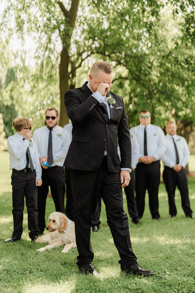 traditional groom tearing up after seeing bride wedding 