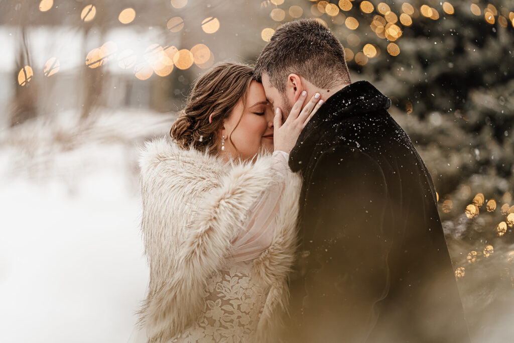 Bride and groom forehead to forehead winter photo