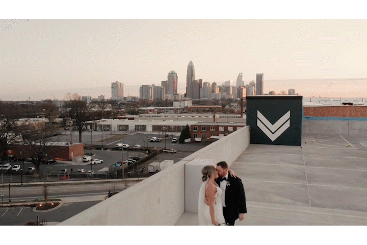 Couple in front of Charlotte skyline dancing