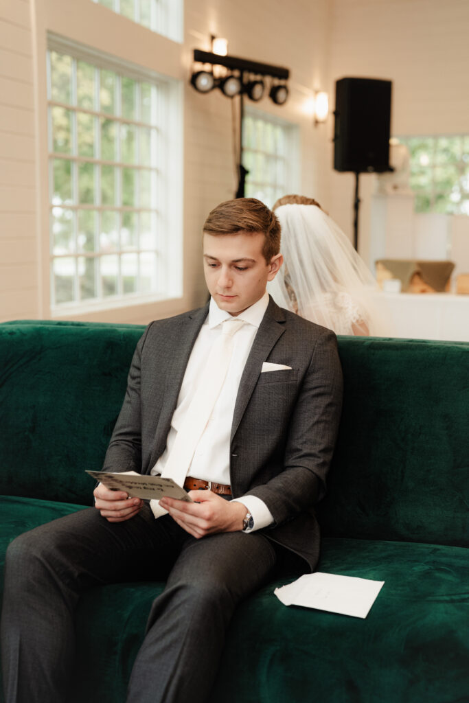 groom reading his letter to bride