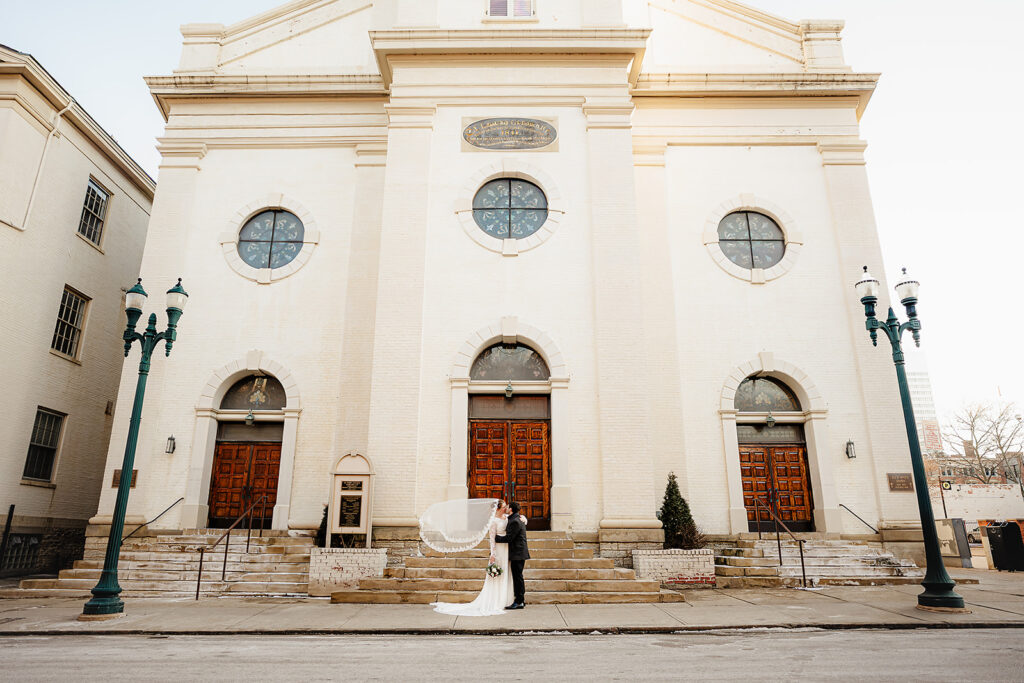 Portrait of bride and groom outside St. Mary's Catholic Church 