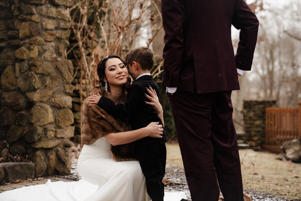 portrait during first look bride hugging her son