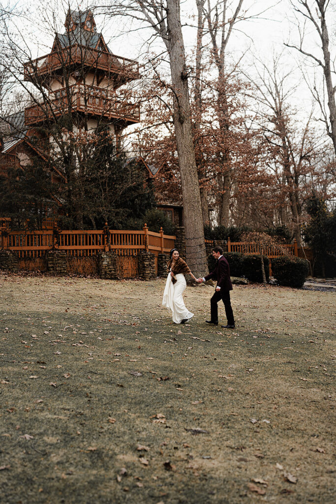 Portrait of bride and groom walking in front of castle 