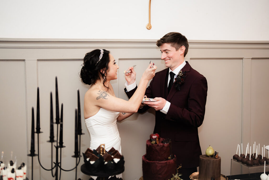 portrait of bride and groom cake cutting